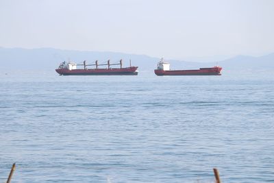 Boat sailing in sea against sky