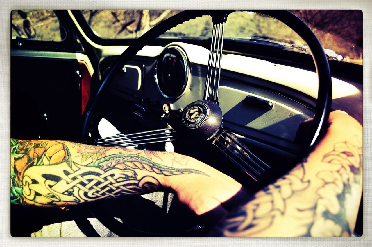 transfer print, transportation, mode of transport, land vehicle, auto post production filter, car, vehicle interior, travel, part of, car interior, person, low section, lifestyles, sitting, leisure activity, close-up, steering wheel