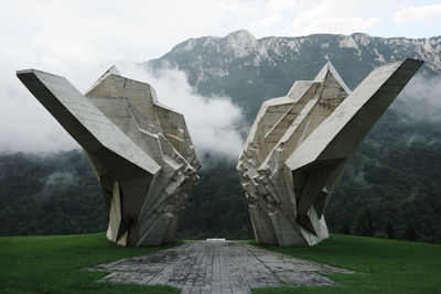 Bridge over mountain against sky