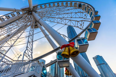 Low angle view of ferris wheel against buildings