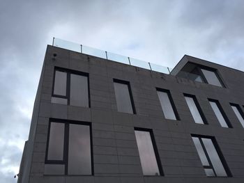 Low angle view of building against cloudy sky