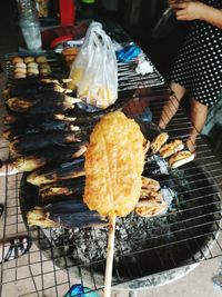 Close-up of preparing food on barbecue grill