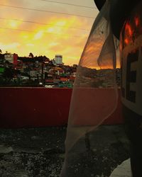 Close-up of buildings against sky during sunset