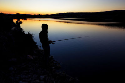 Fishing at sunset near the sea.