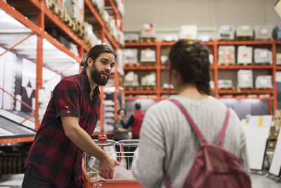 Couple talking while shopping at hardware store