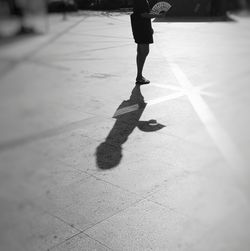 Low section of woman walking on street