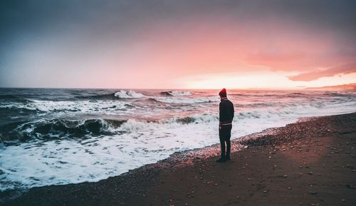 Rear view of man standing on beach