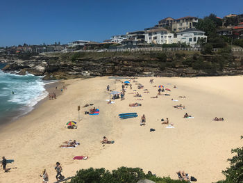 High angle view of people on beach against buildings in city