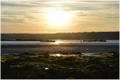 Scenic view of beach against sky during sunset