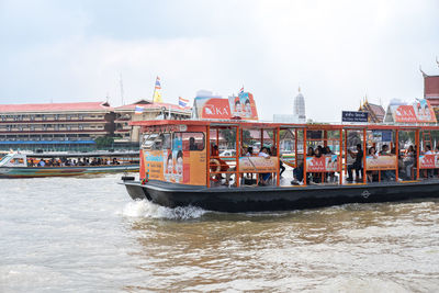 Boats in river with buildings in background