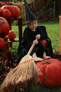 Full length of a boy sitting on field