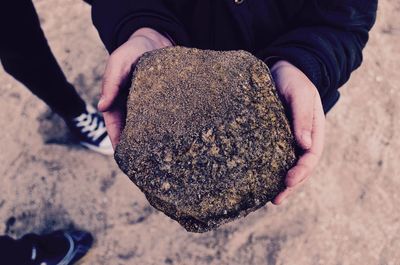 Close-up of woman holding a rock