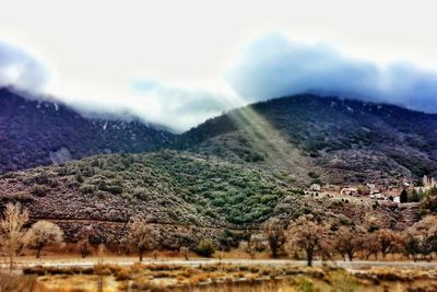 Scenic view of mountains against cloudy sky