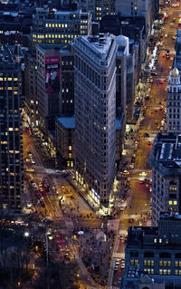High angle view of road by flatiron building in city at dusk