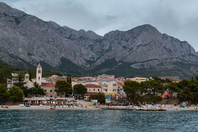 Tourist resort baska voda and main beach, in croatia against mountain biokovo at summer dusk