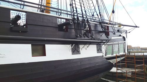 Low angle view of boats moored at harbor against sky