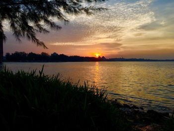 Scenic view of lake against sky during sunset