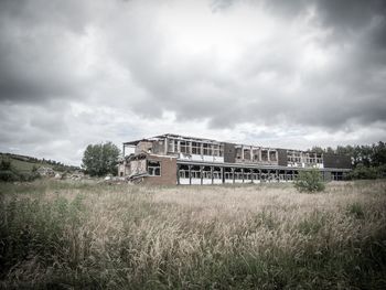 View of grassy field against cloudy sky