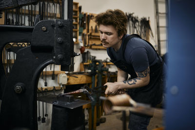 Blacksmith working in his workshop