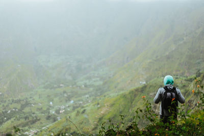 A tourist with backpack admire the rural landscape  in xo-xo valley. santo antao island. cape verde