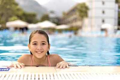 Portrait of happy boy swimming in pool