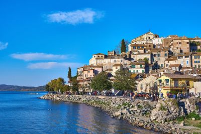 View of townscape by sea against sky