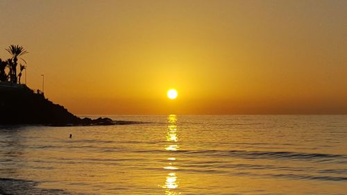 Scenic view of sea against clear sky during sunset