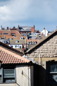 Houses in city against sky