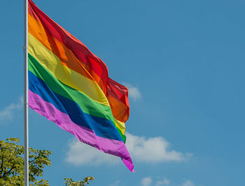 Low angle view of flag against blue sky