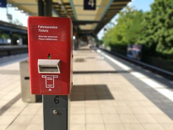 Close-up of stop sign on railroad station platform