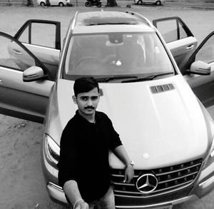 Portrait of young man sitting in car