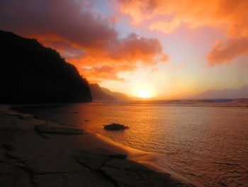 Scenic view of sea against orange sky