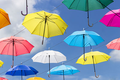 Multi colored umbrella against sky during rainy season