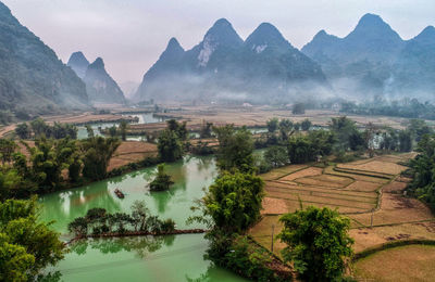 Scenic view of lake and mountains against sky