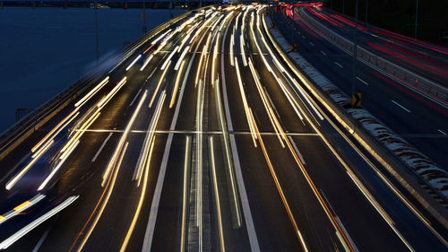 High angle view of light trails on road at night