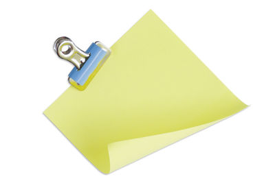 High angle view of yellow paper over white background