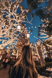 Woman with illuminated christmas tree
