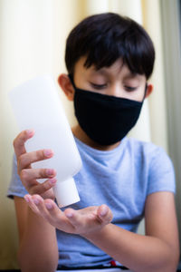 Boy taking sanitizer on hand