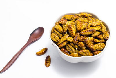 Close-up of food in plate against white background