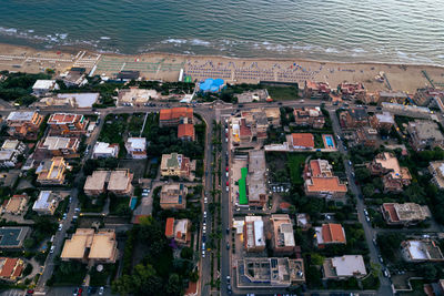 Aerial high angle view of buildings in city by sea, lavinio mare, anzio, italy by drone 