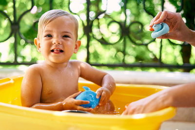 Portrait of shirtless boy in park