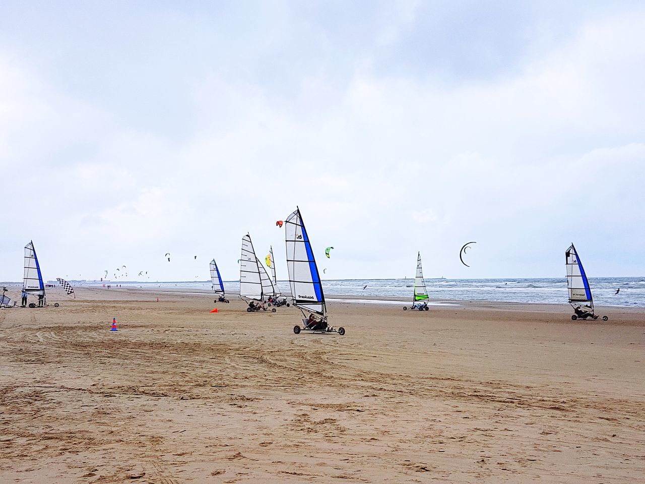 sand, beach, sea, sky, water, day, nature, cloud - sky, outdoors, beauty in nature, horizon over water, scenics, vacations, nautical vessel, real people, sport, beach volleyball