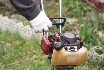 Close-up of person holding camera on field