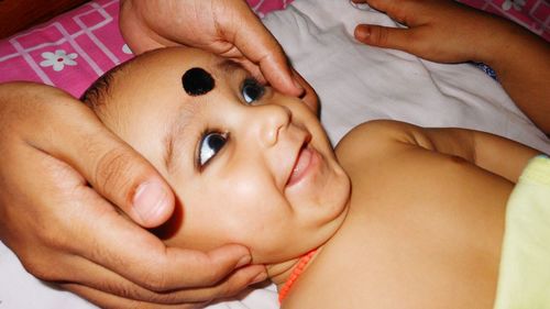 Close-up of mother holding baby