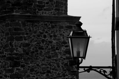 Close-up of electric lamp on stone wall