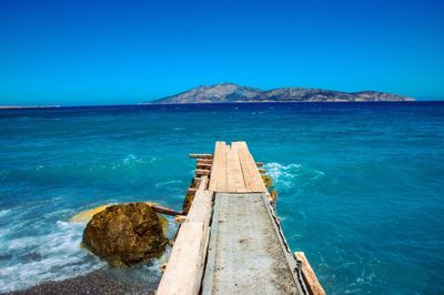 Pier on sea against clear sky