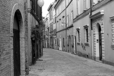 Empty alley amidst buildings in city