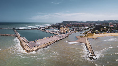 High angle view of sea and cityscape against sky