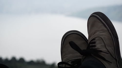 Low section of person against sky