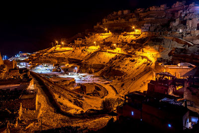High angle view of illuminated buildings in city at night
